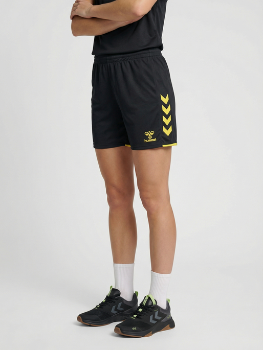 hmlCORE 2.0 SHORTS WOMAN, BLACK/BLAZING YELLOW, model